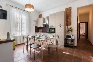 eine Küche und ein Esszimmer mit einem Tisch und Stühlen in der Unterkunft Conce Apartment in Pisa