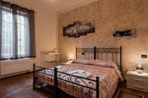 a bedroom with a bed and a large window at Conce Apartment in Pisa