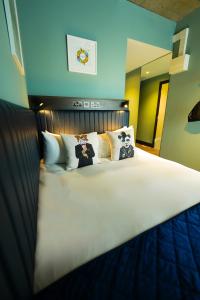 a bedroom with a large bed with pillows at Dublin One in Dublin