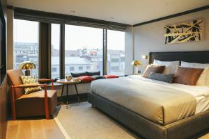 a bedroom with a large bed and a large window at Root Karaköy in Istanbul