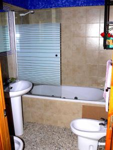 y baño con aseo, bañera y lavamanos. en Casa Lino Huesca, en Chibluco