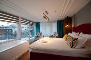 a bedroom with a bed and a tub and a window at Blue Mosque Suites 2 - Old City Sultanahmet in Istanbul
