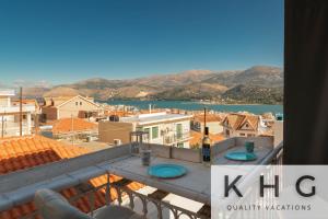 a view of a city from the balcony of a house at KEFALONIA'S HIDDEN GEMS! in Argostoli