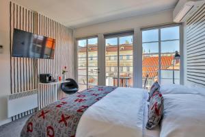 a bedroom with a bed and a large window at LH Vintage Design Hotel Sax in Prague