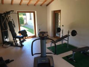 a room with a gym with weights and a treadmill at Agriturismo Le Fornaci - Camera Ginestra in Mercatale