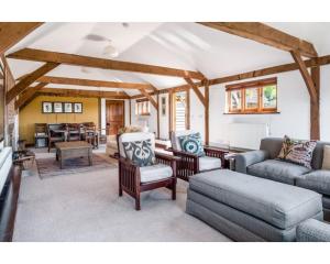 a living room with a couch and chairs and a table at Huish Lodge in Radstock