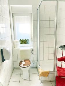 a bathroom with a toilet with a window and a tub at Spreewaldhof in Vetschau +35 photos