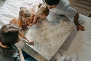 a group of people looking at a map on a bed at Basekamp Mountain Budget Hotel in Katschberghöhe
