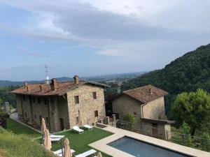 a house with a swimming pool in front of it at Cascina Belvedì in Clanezzo