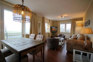 a living room with a table and a couch at Villa Seeluft - by Rujana in Ostseebad Sellin