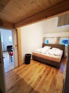 a bedroom with a bed and a wooden floor at Ferienwohnung Fuchs in Münster