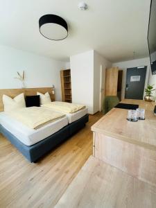 a bedroom with a large bed and a table at Creo München Süd in Munich