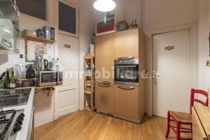 a kitchen with a stove and a refrigerator in it at Incantevole appartamento accanto fondazione Prada in Milan