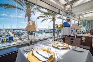 a dining room with a view of a marina at LAP- 3 bed apartment on the beach. Families only in Casares