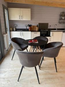 a kitchen with a table and chairs in a kitchen at Cromwell Lodge, Cromer, moments from the beach! in Cromer