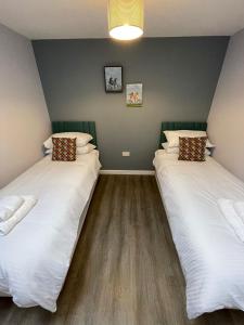 Ένα ή περισσότερα κρεβάτια σε δωμάτιο στο Cromwell Lodge, Cromer, moments from the beach!