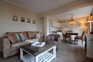 a living room with a couch and a table at Villa Seeluft - by Rujana in Ostseebad Sellin