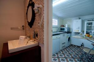 a small kitchen with a sink and a mirror at Blue Mosque Suites-Old City Sultanahmet in Istanbul