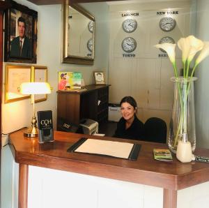 a woman sitting at a desk in an office at Atlantic Hotel in Lahinch