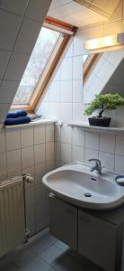 a bathroom with a sink and a window at Kleine Auszeit Pellworm in Pellworm