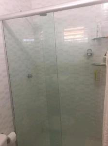 a glass shower door in a bathroom at Vista pro mar maravilhosa,Tibau-RN - INNOVA in Tibau