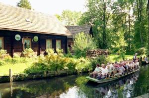 a group of people riding in boats down a river at Spreewaldhof in Vetschau