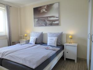 a bedroom with a large bed with two night stands at Scheitz 1 in Dahme