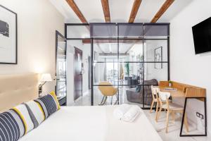 a bedroom with a bed and a dining room at Modern&Confort Premium Concept Ruzafa , , ValenciaGUEST in Valencia