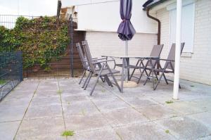 a patio with a table and chairs and an umbrella at Scheitz 1 in Dahme