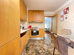 a kitchen with wooden cabinets and a counter top at Miguel Torga Diamond Penthouse in Coimbra