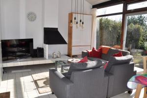 a living room with a couch and a fireplace at Boerenslag 10 in Sint Maartensvlotbrug