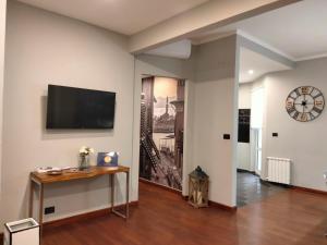sala de estar con TV de pantalla plana en la pared en Casa di Ravecca, en Génova