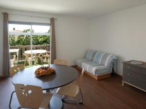 a living room with a table and a couch at ULVF Les Girelles in Saint Pierre La Mer