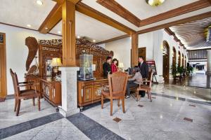 a group of people sitting at a table in a lobby at Kusuma Sahid Prince Hotel Solo in Solo