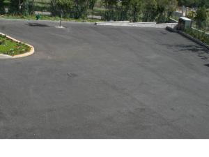 an empty parking lot with a parking meter in the middle at Hotel Apulia in San Giovanni Rotondo