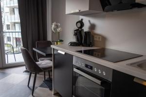 a kitchen with a stove top oven next to a sink at Giessener Bett in Gießen