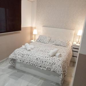 Posteľ alebo postele v izbe v ubytovaní Apartamentos centro histórico