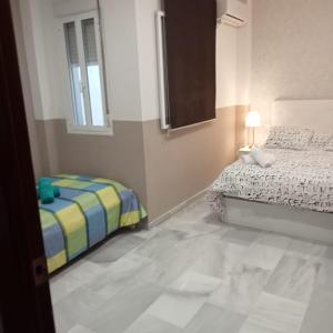 Posteľ alebo postele v izbe v ubytovaní Apartamentos centro histórico