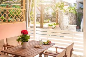 a wooden table with a bowl of fruit on a patio at Τrilogy Studios in Syvota