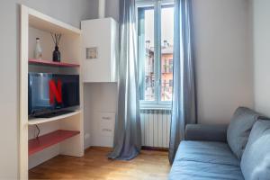 a living room with a couch and a window at [NAVIGLI-DUOMO] Apartment with Netflix+Wifi in Milan
