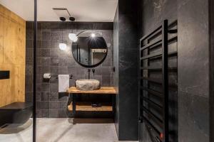 a bathroom with a sink and a mirror at Mountain Forest in Białka Tatrzanska +27 photos