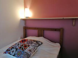 a small bed with a pillow on top of it at Captains Log House in Baleal