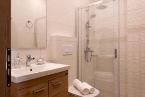 a bathroom with a sink and a glass shower at Τrilogy Studios in Syvota