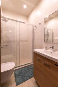 a bathroom with a shower and a sink and a toilet at Τrilogy Studios in Syvota