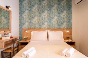 a bedroom with a bed and a large painting on the wall at Τrilogy Studios in Syvota