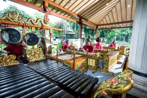 a group of people riding on a carousel at Kusuma Sahid Prince Hotel Solo in Solo