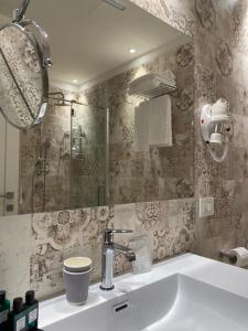a bathroom with a sink and a mirror at EUROPA Hotel in Vasto