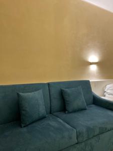 a blue couch with pillows in a room at EUROPA Hotel in Vasto