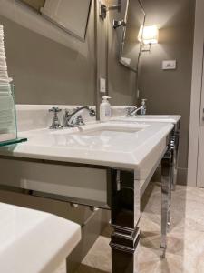 a bathroom with a white sink and a mirror at EUROPA Hotel in Vasto