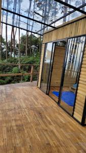 Latibule Glamping في لا فيغا: منزل بأبواب زجاجية وسطح خشبي